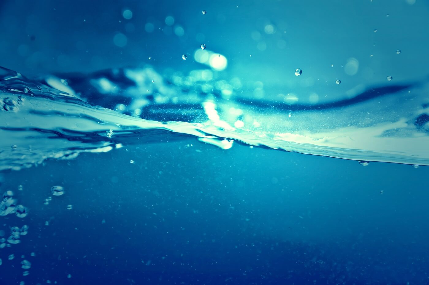 Altitude Water atmospheric water generator benefits are illustrated by a clean blue water surface, symbolizing sustainable home water independence and purified drinking water.